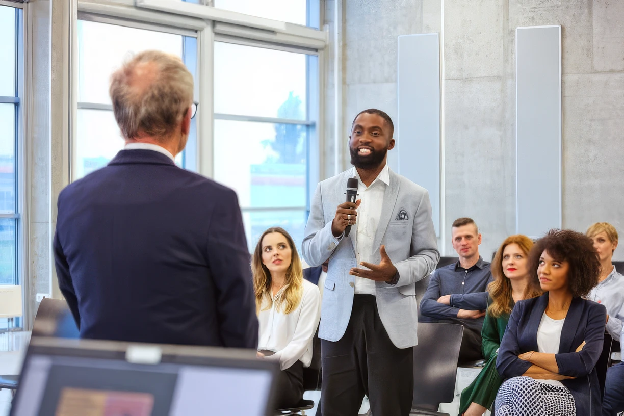 A speaker takes the floor to a room of business owners